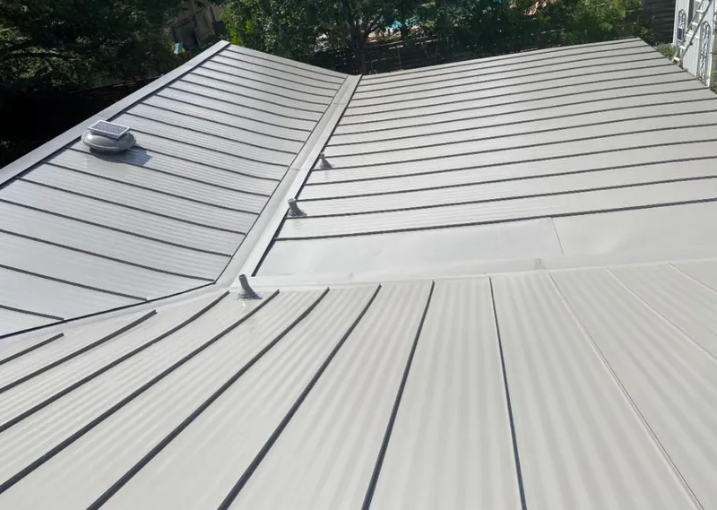 Solar attic fan installed on a metal roof for Roof Ventilation in Villas